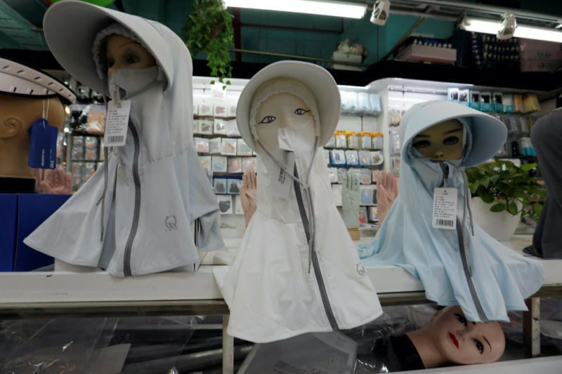 Mannequins with sun protection headgear are seen displayed at a store in a shopping mall, amid a yellow alert for heatwave in Beijing, China, on 19th July, 2023.