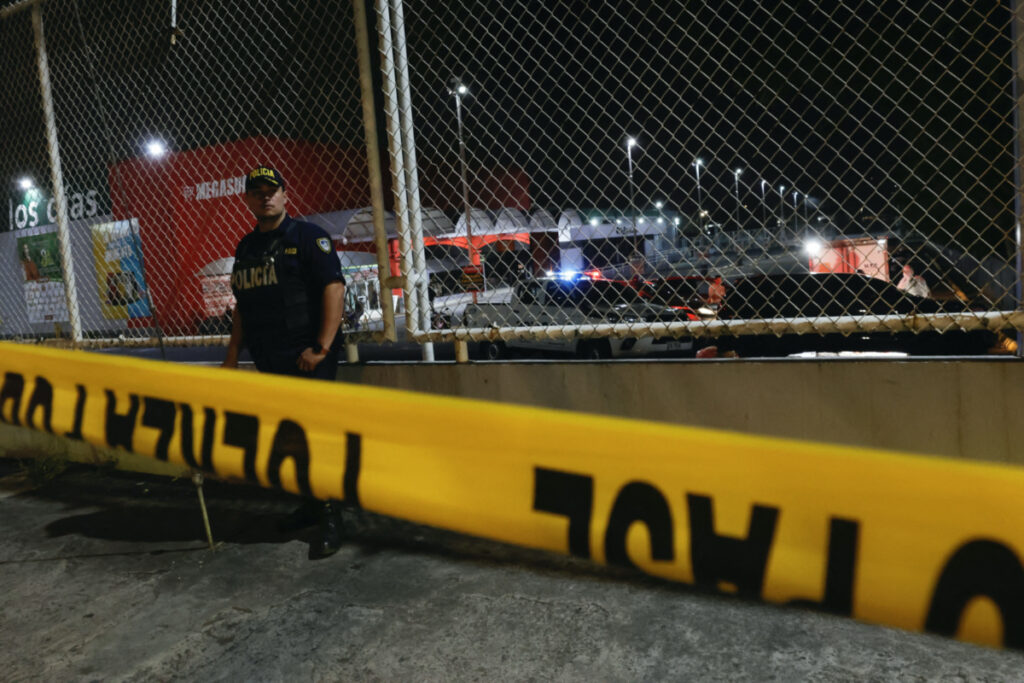 Police detectives work at a scene in the parking lot of a supermarket where a man was gunned down during a shooting with unknown assailants, according to local media, in the town of Desamparados, in San Jose, Costa Rica, on 26th April, 2023.