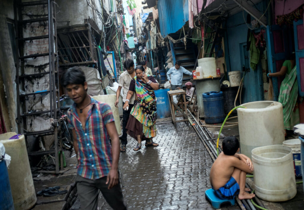 Residents walk in an alley in Dharavi, one of Asia's largest slums, in Mumbai, on 12th March, 2015.