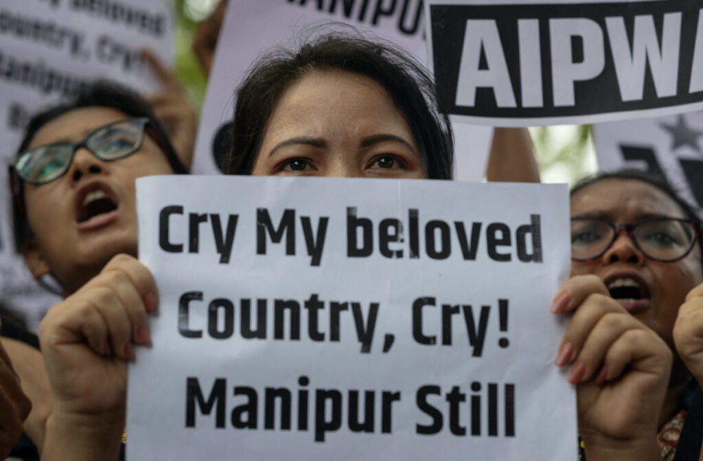 Protestors hold placards as they attend a protest against the alleged sexual assault of two tribal women in the eastern state of Manipur, in New Delhi, India, on 21st July, 2023.
