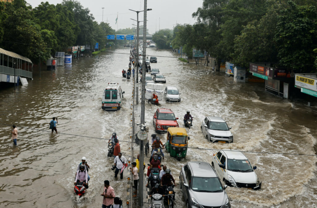 Traffic moves through a flooded road, after a rise in the waters of river Yamuna due to heavy monsoon rains, in New Delhi, India, on 14th July, 2023