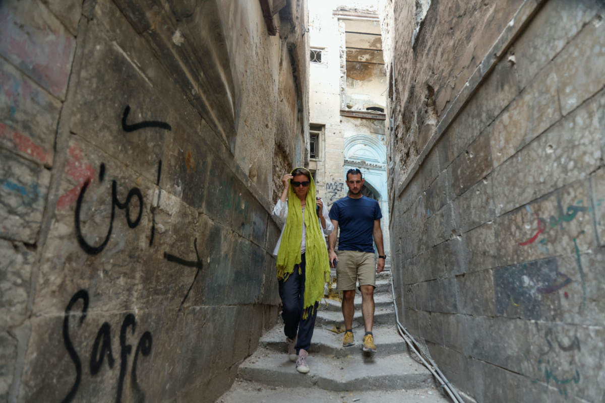 Anna Nikolaevna, 38, a Russian national, and Jacob Nemec, 29, an American national, walk during a tour of the old city of Mosul, Iraq, on 7th June, 2023.
