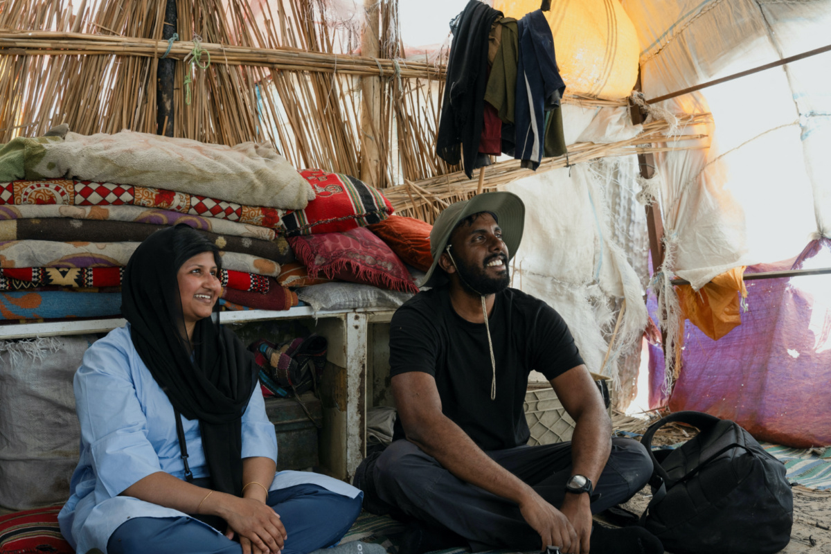 Lorin and Galton Lenie, French tourists of Sri Lankan descent, who are on their first visit to Iraq, sit in a local home during a tour of the marshes, within Chibayish in Nassiriya, Iraq, on 14th June, 2023.