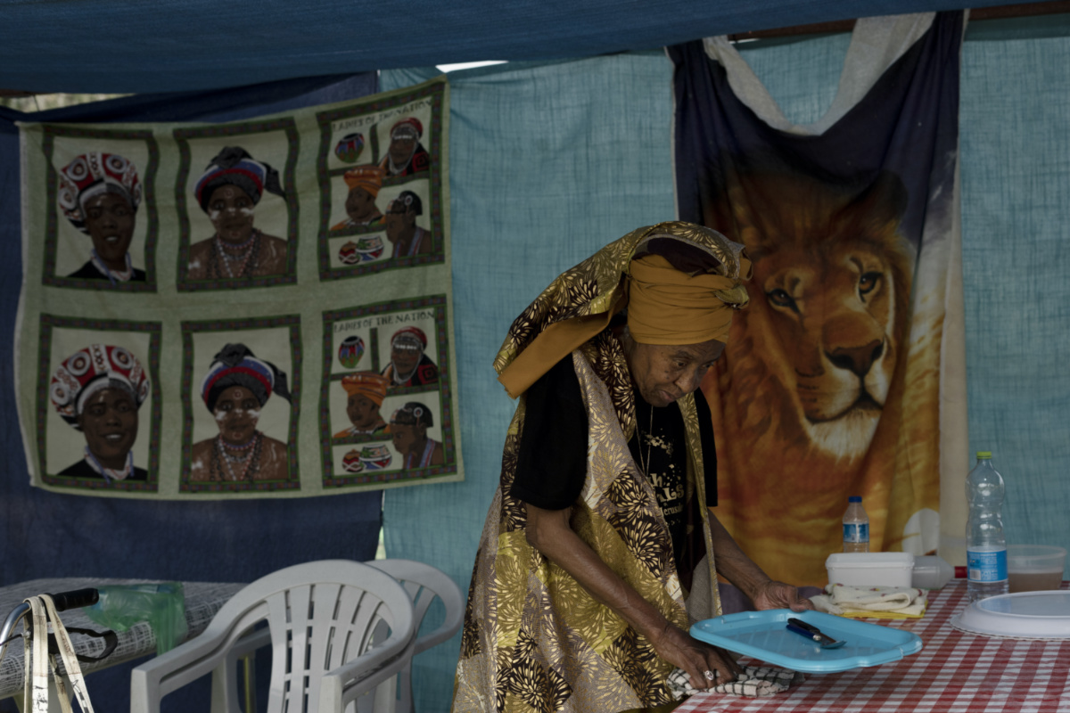 An elderly woman from the Hebrew Israelite community tidies her family tent during New World Passover celebrations marking the group's exodus from the United States, in Dimona, Israel, on Thursday, 1st June, 2023.