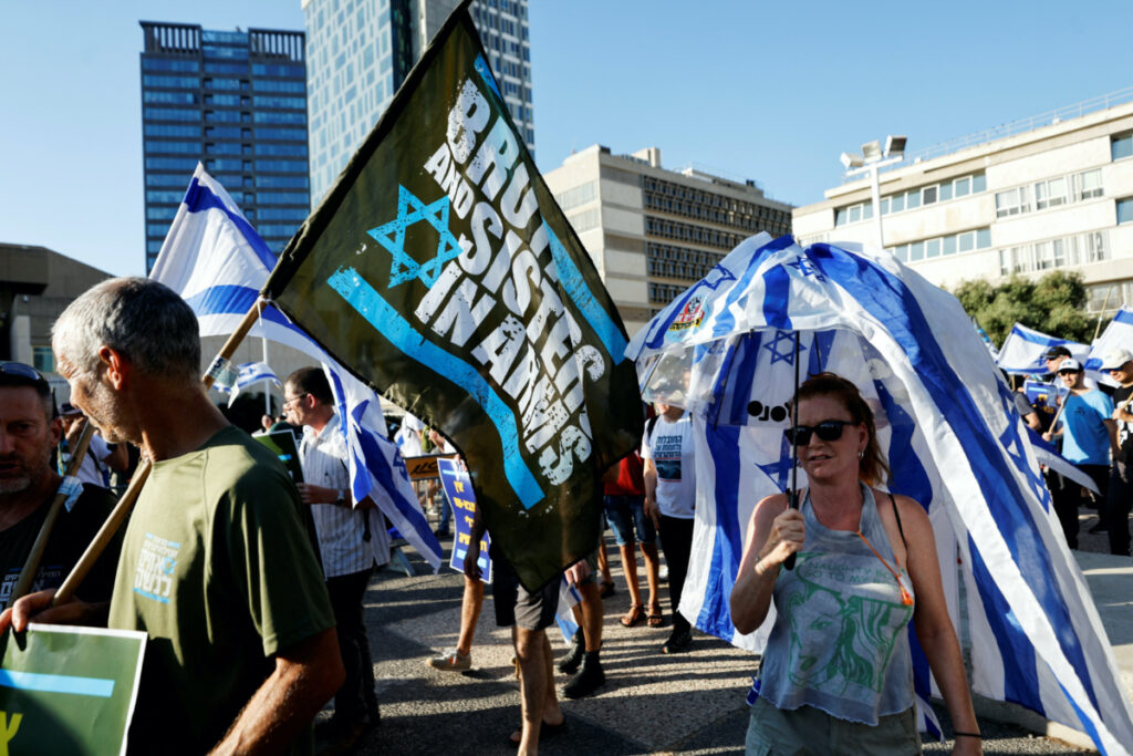 Israelis take part in a protest where military reservists sign pledge to suspend voluntary military service if the government passes judicial overhaul legislation near the defence ministry in Tel Aviv, Israel, on 19th July, 2023.