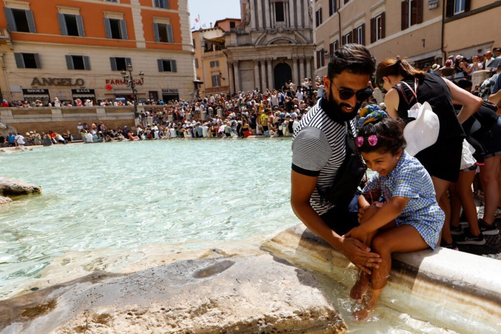 People cool themselves at the Trevi Fountain during a heatwave across Italy as temperatures are expected to cool off in Rome, Italy, on 20th July, 2023