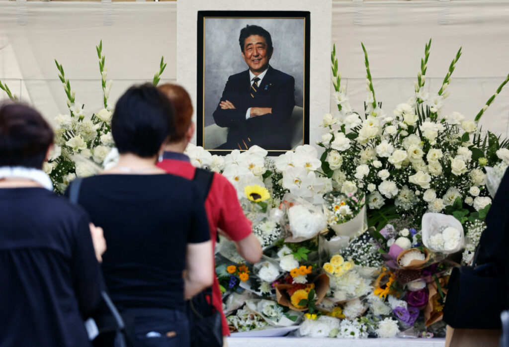 Mourners offer flowers and prayers for the late Japanese Prime Minister Shinzo Abe, who was shot while campaigning for a parliamentary election in 2022, during the one year commemoration ceremony of his assassination at Zojoji temple in Tokyo, Japan, on 8th July, 2023.