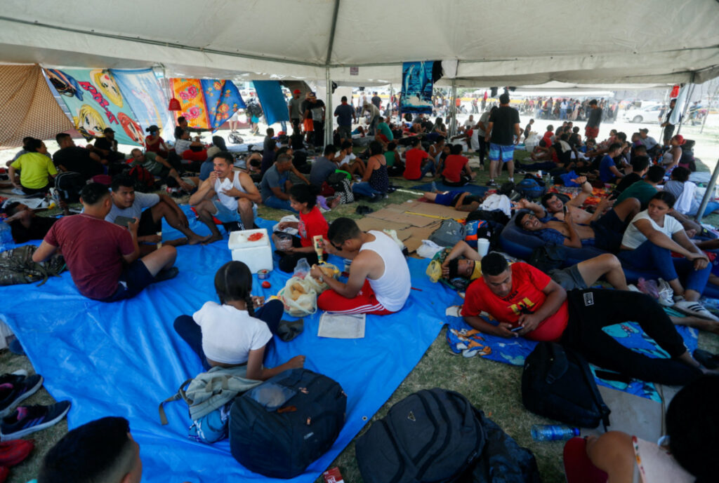 Asylum seekers, mostly from Venezuela, rest in the shade of a tent set up by Mexican authorities near the border as they try to cross into the US without an appointment, in Nuevo Laredo, Mexico on 27th June, 2023