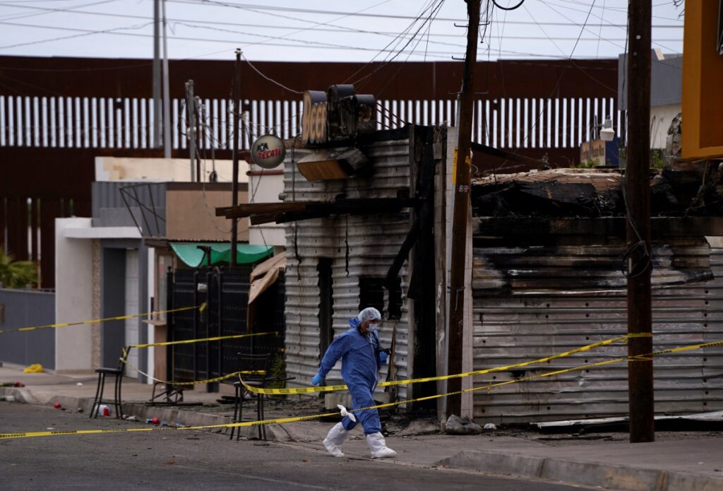 A forensic technician works at a scene where a man threw a Molotov cocktail bomb after being kicked out of a bar for bad behaviour, leaving several victims, according to Sonora state authorities, in San Luis Rio Colorado, Mexico, on 22nd July, 2023