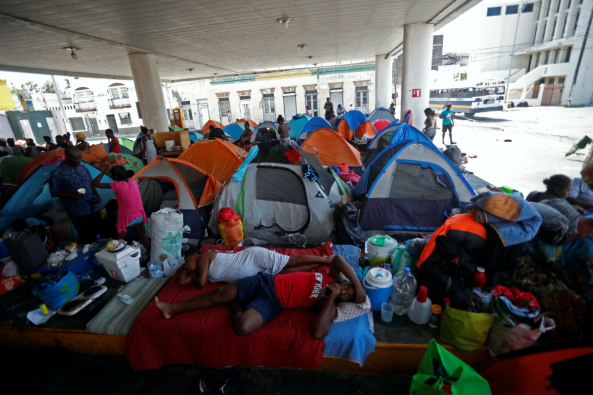 Haitian asylum seekers set up camp in an abandoned gas station while they wait to attempt to cross into the US by an appointment through the Customs and Border Protection app, called CBP One, at a makeshift camp, in Matamoros, Mexico on 21st June, 2023. 