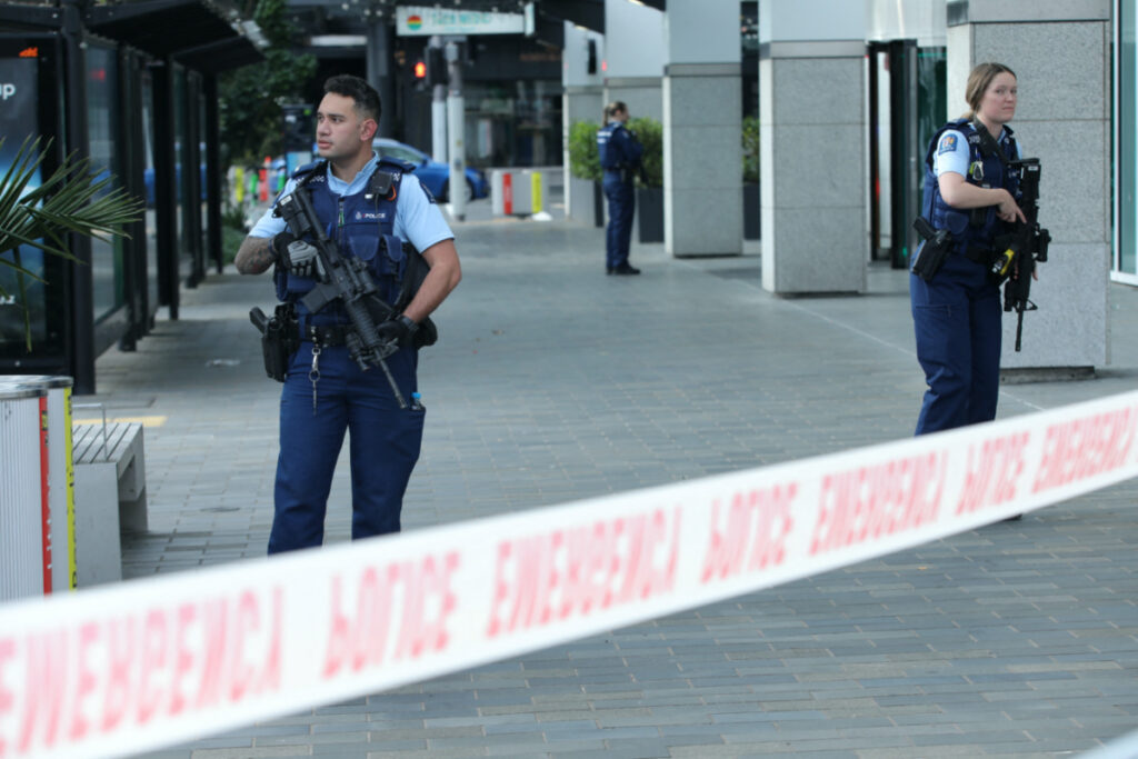 Police officers stand guard near the location of a reported shooting in Auckland, New Zealand on 20th July, 2023.