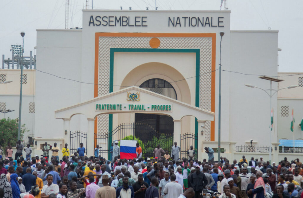 Hundreds of supporters of the coup gather and hold a Russian flag in front of the National Assembly in the capital Niamey, Niger, on 27th July, 2023.