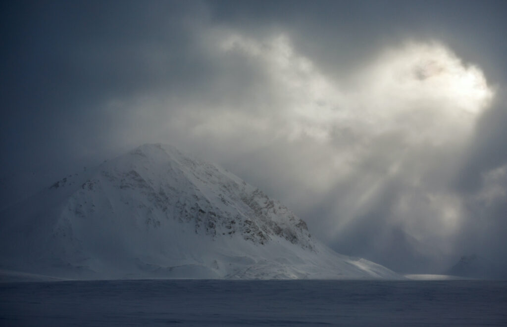 The sun shimmers through a cloud cover near Ny-Alesund, Svalbard, Norway, on 8th April, 2023.