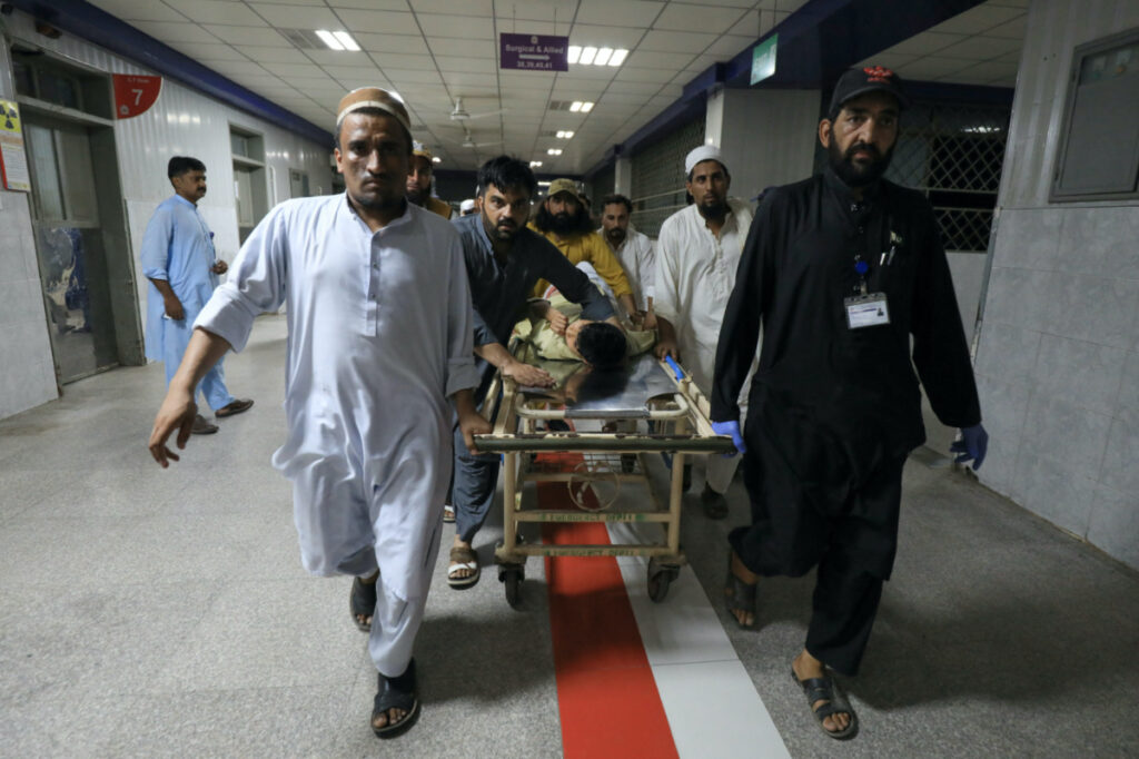 People transport a man, who was injured after a blast in Bajaur district of Khyber Pakhtunkhwa, at the Lady Reading Hospital in Peshawar, Pakistan, on 30th July, 2023.