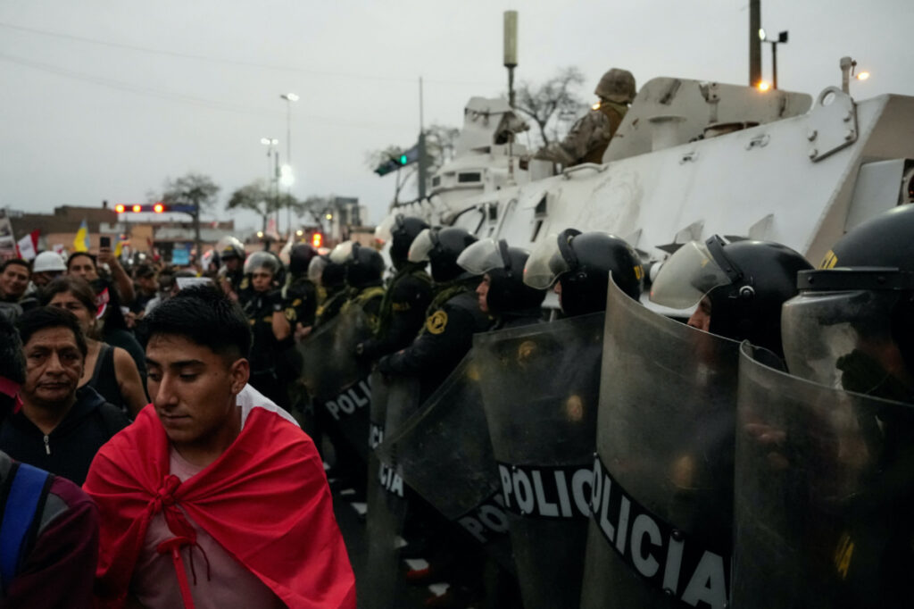 Riot police officers stand guard as anti-government demonstrators protest against President Dina Boluarte in Lima, Peru, on 19th July, 2023.