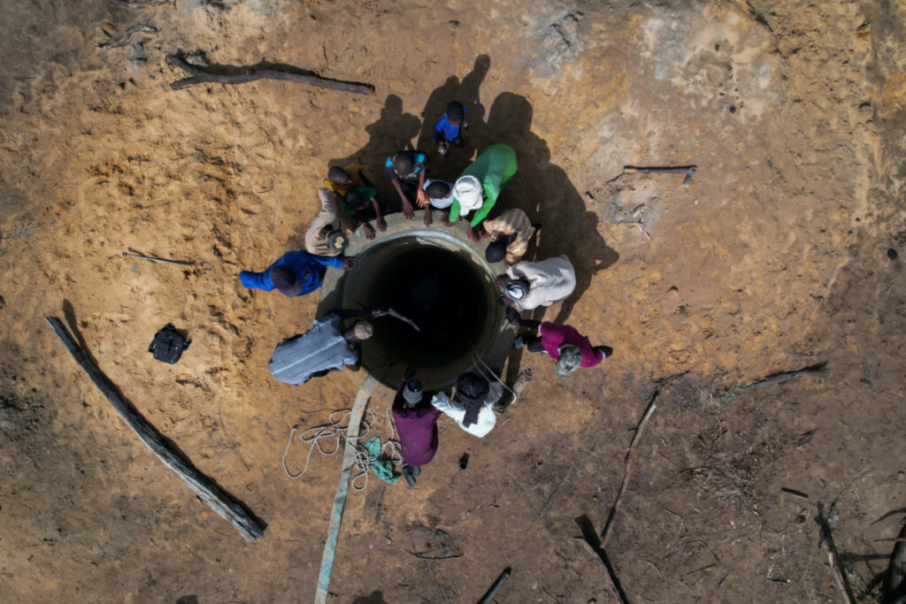 Workers and villagers gather around a well, being built with the help of crowdfunding, in Ourou Amady Bagga, Podor region, Senegal, on 8th July, 2023.