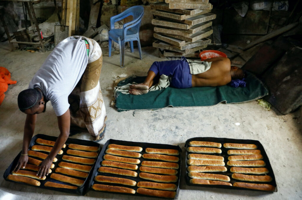 A worker prepares baked goods with wheat from Ukraine as his colleague rests at a bakery, in Hodan district in Mogadishu, Somalia on 16th July, 2023.