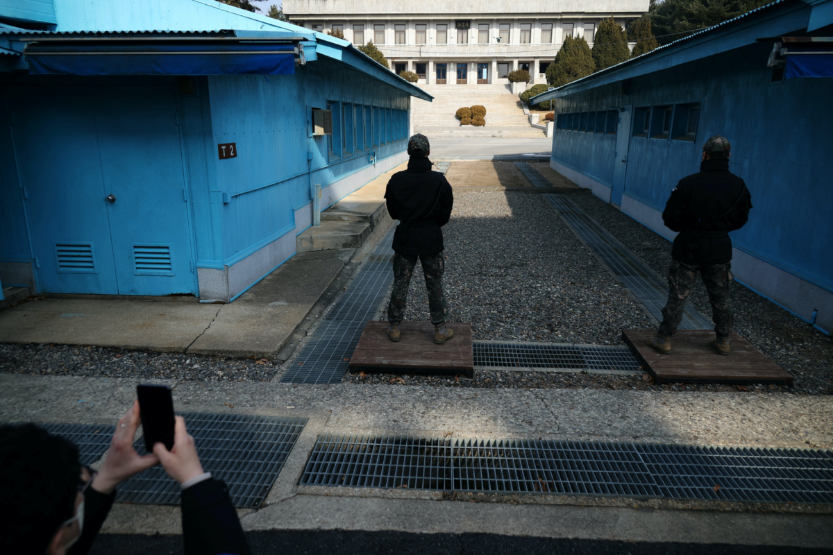 A media member takes a photograph of South Korean soldiers standing guard in the truce village of Panmunjom inside the demilitarized zone separating the two Koreas, South Korea, on 7th February, 2023.   