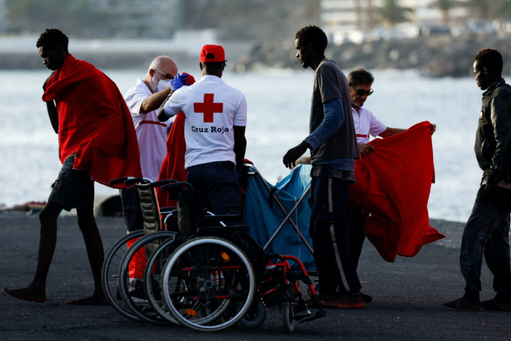 Migrants walk towards a Red Cross tent after disembarking from a Spanish coast guard vessel in the port of Arguineguin, in the island of Gran Canaria, Spain, on 10th July, 2023.