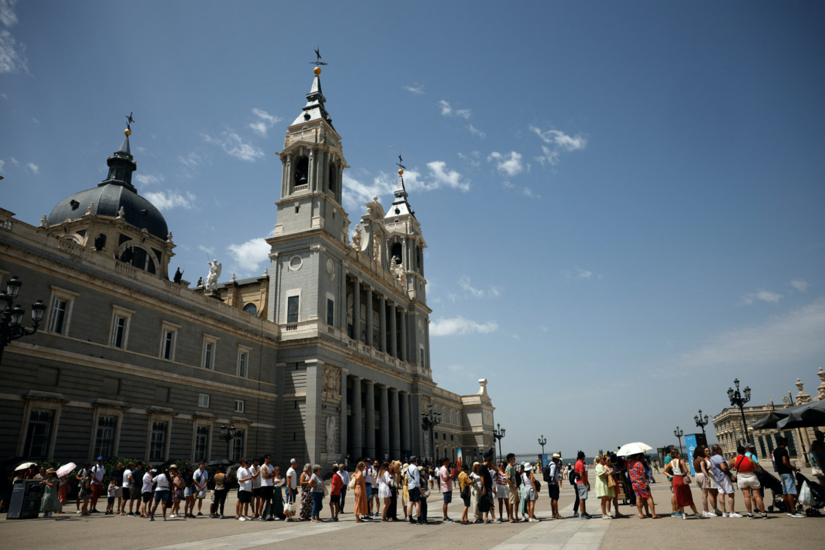 Tourists queue to enter the Royal Palace museum amid a heatwave in Madrid, Spain, on 17th July, 2023.