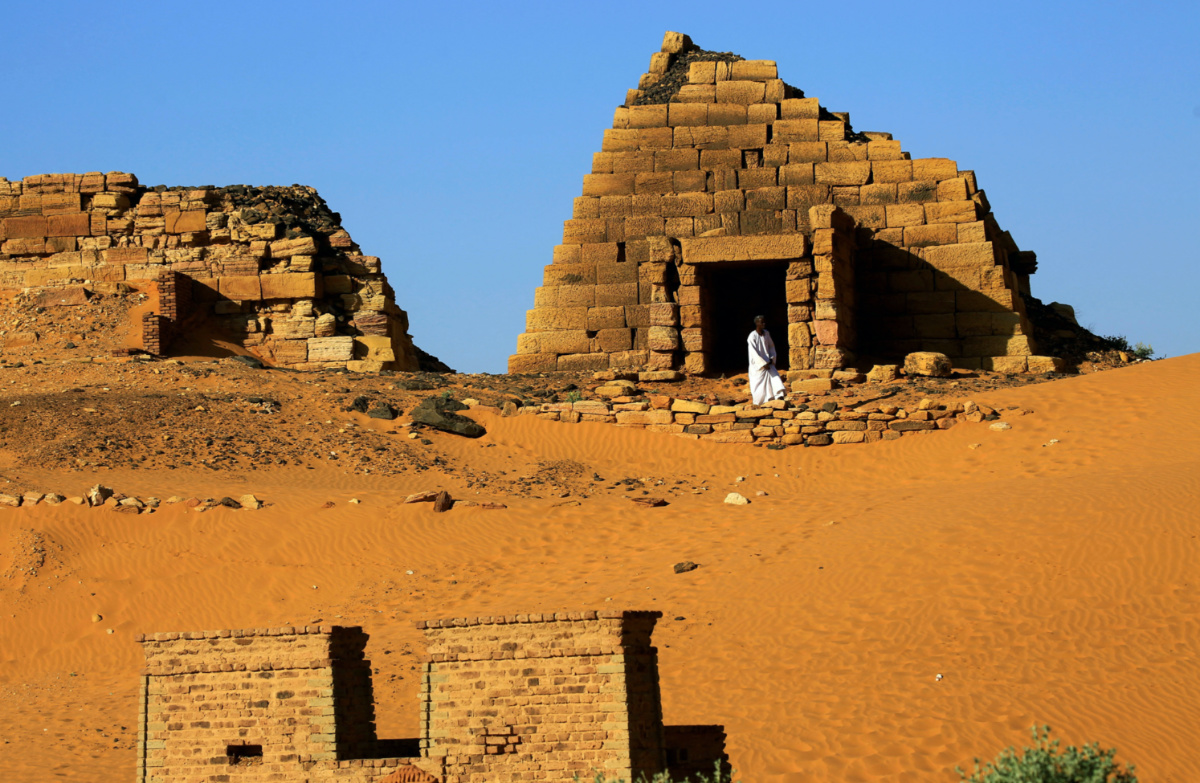 A man walks past the Royal Cemeteries of Meroe Pyramids at Begrawiya in River Nile State, Sudan, on 10th November, 2019. 
