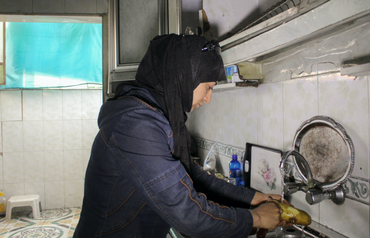 Nesma Daher works in the kitchen in Douma, Syria, on 19th June, 2023.
