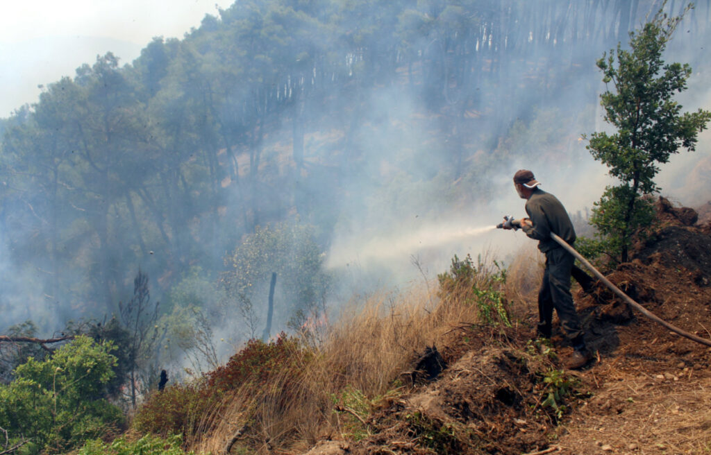 A firefighter attempts to extinguish a wildfire, in the northern countryside of Latakia, Syria, on 29th July, 2023.