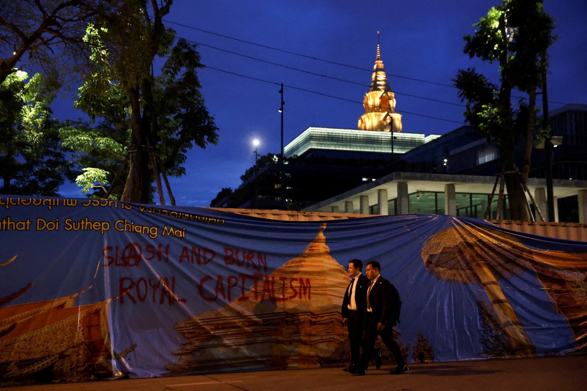 People walk outside the parliament, after Thailand's constitution court ordered the temporary suspension of the Move Forward Party's leader Pita Limjaroenrat from the parliament, in Bangkok, Thailand, on 19th July, 2023.
