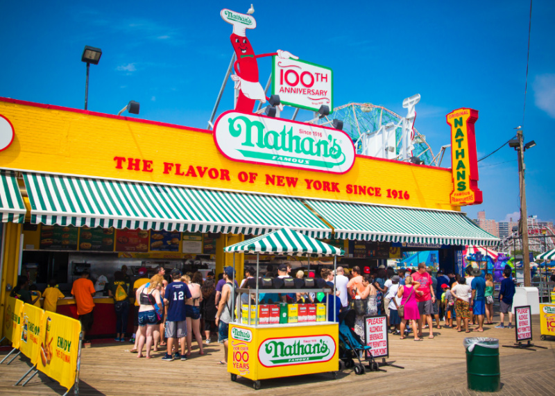 People gather at the famous hot dog restaurant, Nathan's, at Coney Island, NYC
