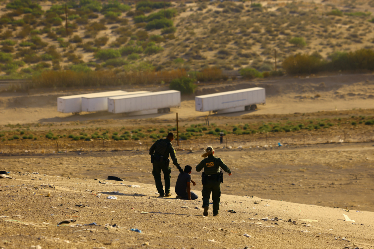 US Border Patrol agents Sean Coffey and Marcia Finnegan apprehend a migrant who attempted to cross the US-Mexico border without detection, near Mount Cristo Rey in Sunland Park, New Mexico, US, on 23rd June, 2023