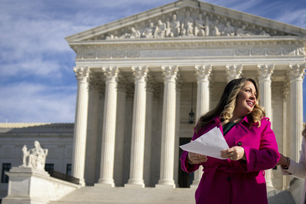 Lorie Smith, a Christian graphic artist and website designer in Colorado, prepares to speak to supporters outside the Supreme Court in Washington, on Monday, 5th December, 2022, after her case was heard by the court.