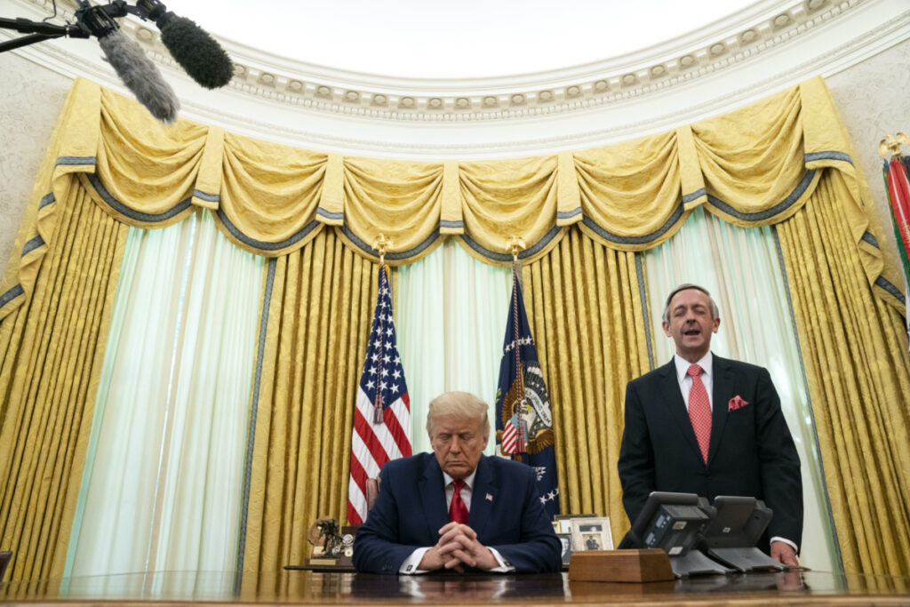 Pastor Robert Jeffress and President Donald Trump pray after Trump signed a full pardon for Alice Johnson in the Oval Office of the White House, Friday, on 28th August, 2020, in Washington.