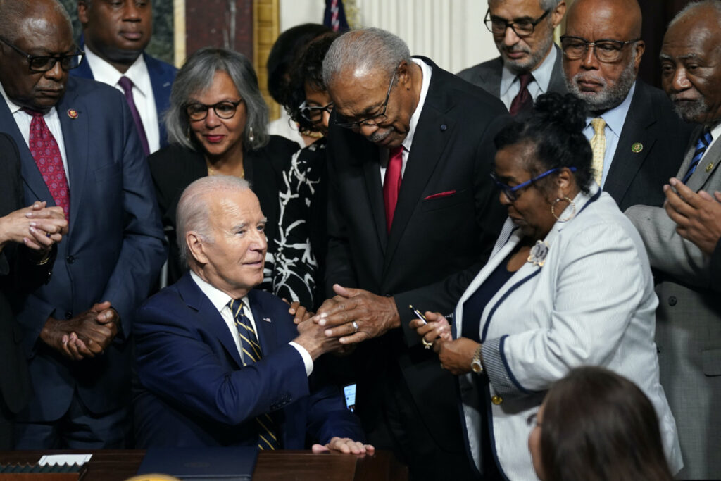 President Joe Biden shakes hands with Rev Wheeler Parker as Marvel Parker holds a signing pen at right, after Biden signed a proclamation to establish the Emmett Till and Mamie Till-Mobley National Monument, in the Indian Treaty Room on the White House campus, on Tuesday, 25th July, 2023, in Washington.