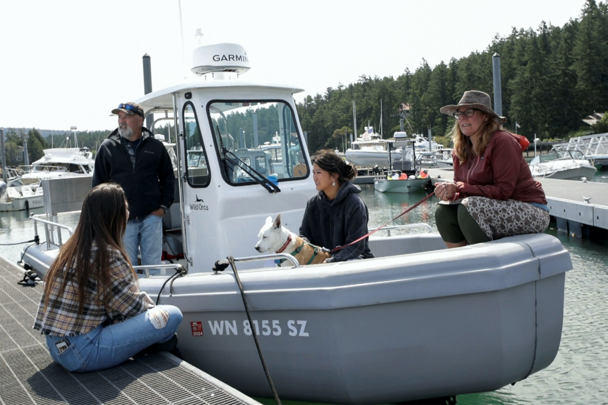 Dr. Deborah Giles, a resident scientist at the University of Washington's Friday Harbor Laboratories, and director of the Wild Orca conservation research organization, sits on her boat with dog Eba, and talks with visitors while moored in Snug Harbor on San Juan Island, Washington, US, on 7th July, 2023