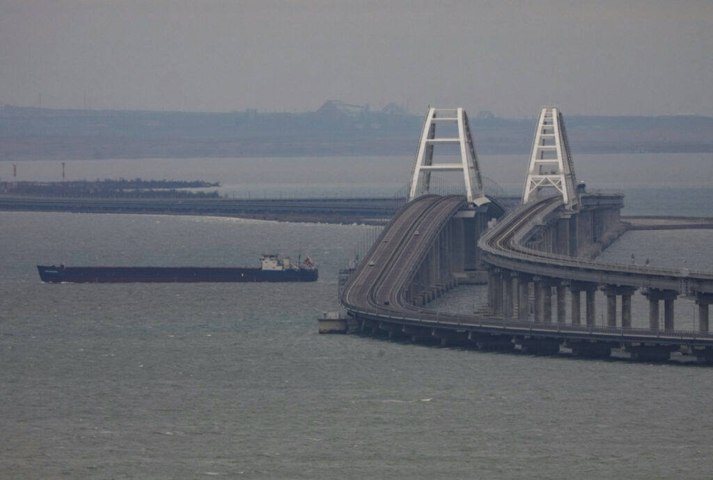 A cargo ship sails next to the Crimea bridge in the Kerch Strait, Crimea, on 14th March, 2023.