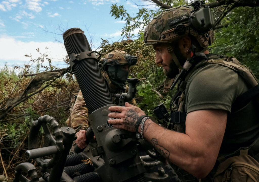 Ukrainian servicemen, of the 10th separate mountain assault brigade of the Armed Forces of Ukraine, prepare to fire a mortar at their positions at a front line, amid Russia's attack on Ukraine, near the city of Bakhmut in Donetsk region, Ukraine, on 13th July, 2023.