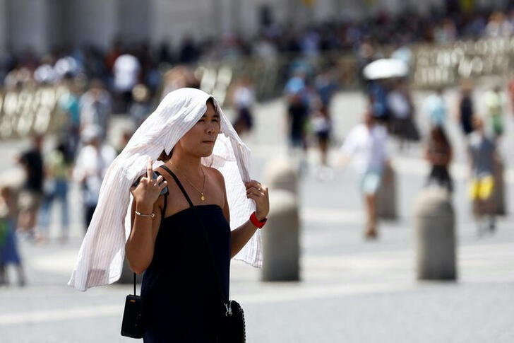 A woman walks during a heatwave across Italy, in Vatican, on 19th July, 2023