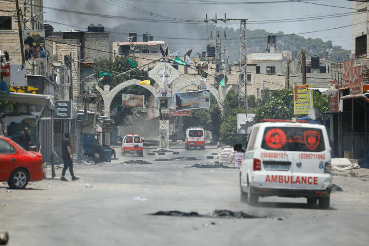 Smoke rises as ambulances drive during an Israeli military operation in Jenin, in the Israeli-occupied West Bank, on 3rd July, 2023