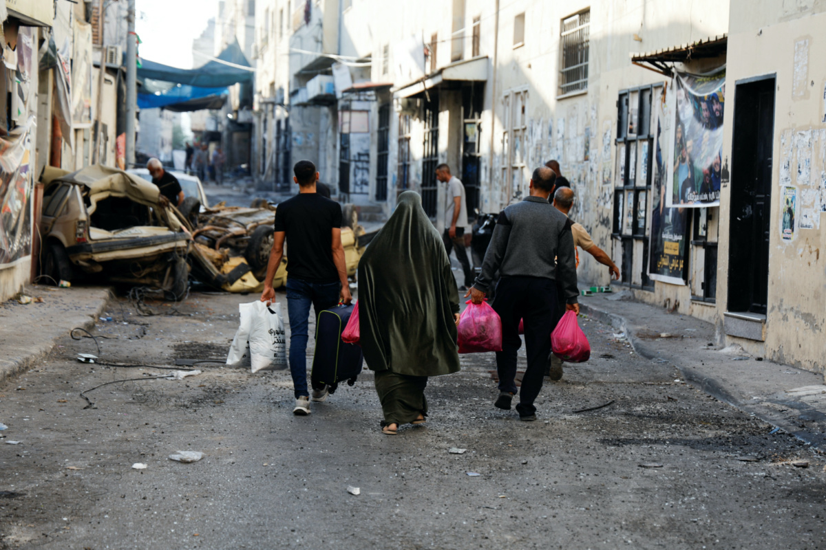 People carry their belongings on the street after the Israeli army's withdrawal from the Jenin camp, in Jenin, in the Israeli-occupied West Bank, on 5th July, 2023.