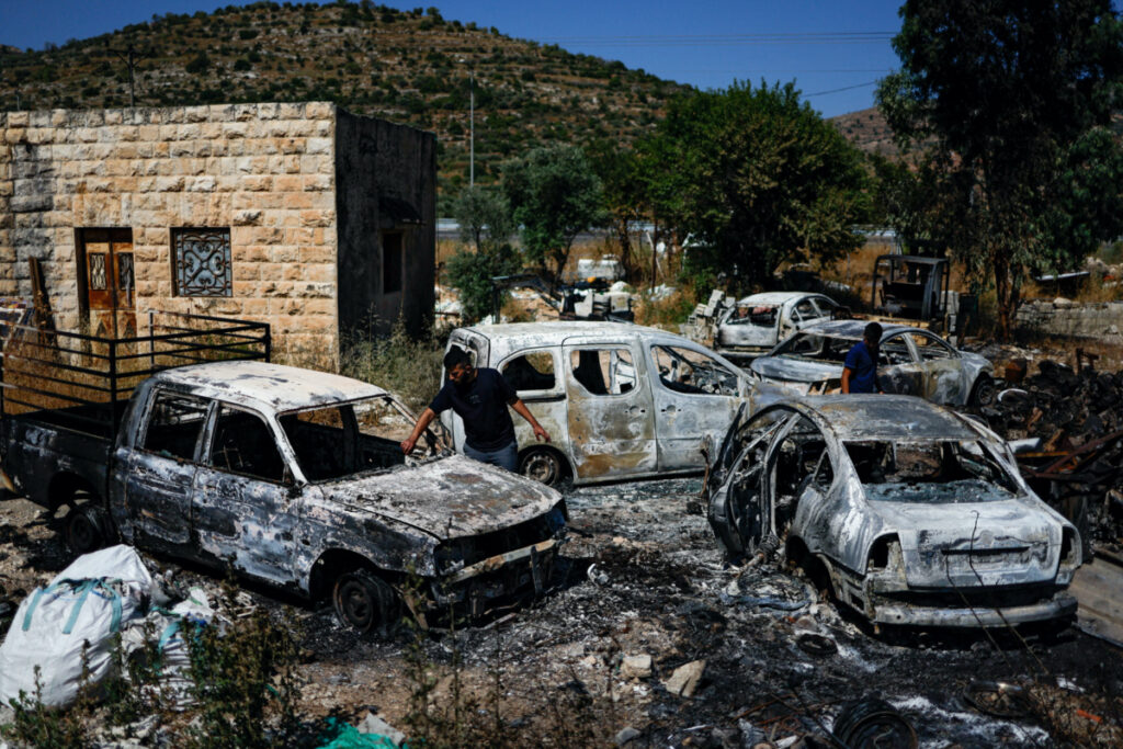 Palestinians check burned vehicles after Israeli settlers attack near Ramallah in the Israeli-occupied West Bank, on 21st June,2023.