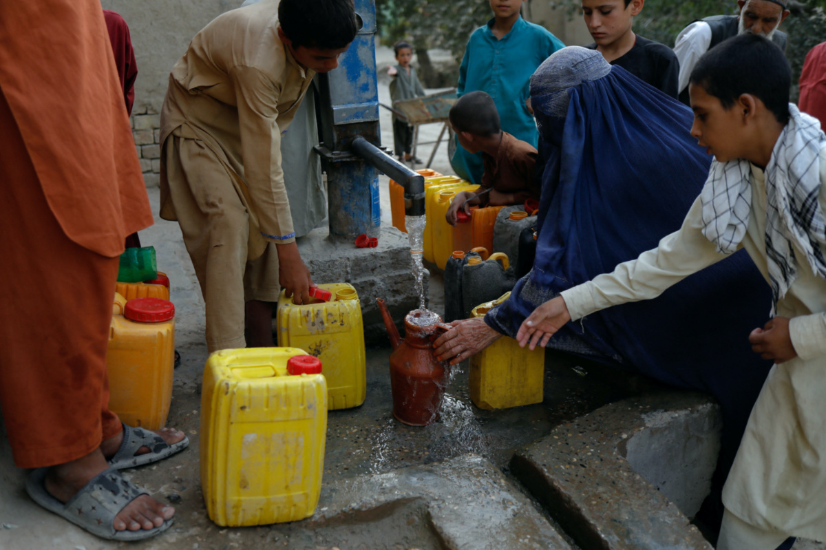 Afghan people crowd around a water tap to fill their containers in Nahr-e-Shahi district in Balkh province, Afghanistan, on 6th August, 2023.