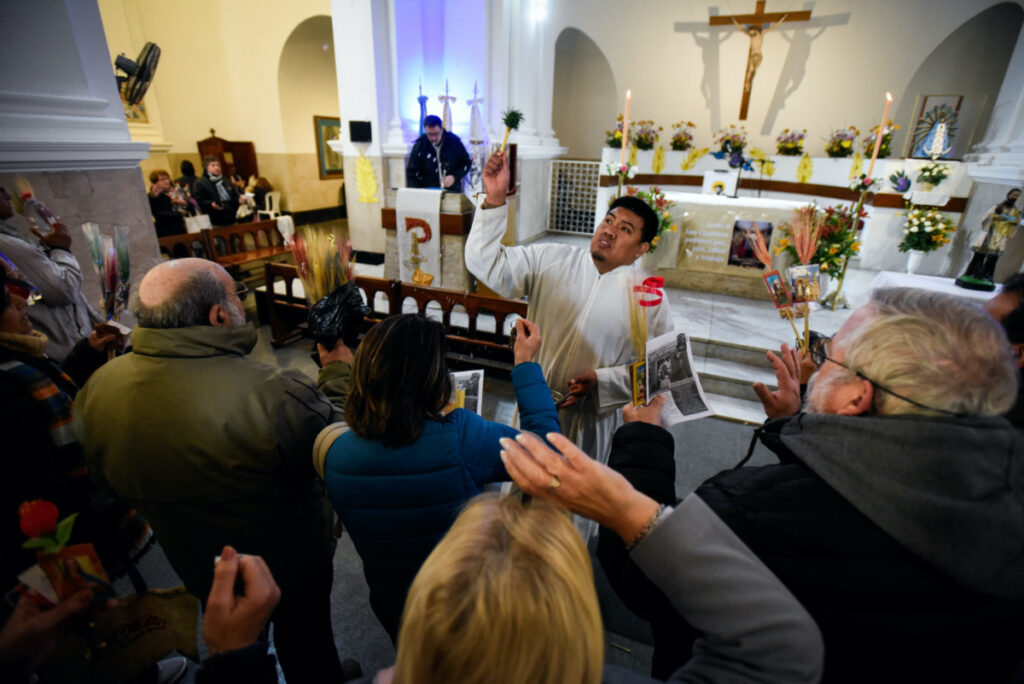 A priest blesses Argentine faithfuls during San Cayetano's feast day, the patron saint of labour and bread, at San Cayetano church in Buenos Aires, Argentina, on 7th August, 2023.