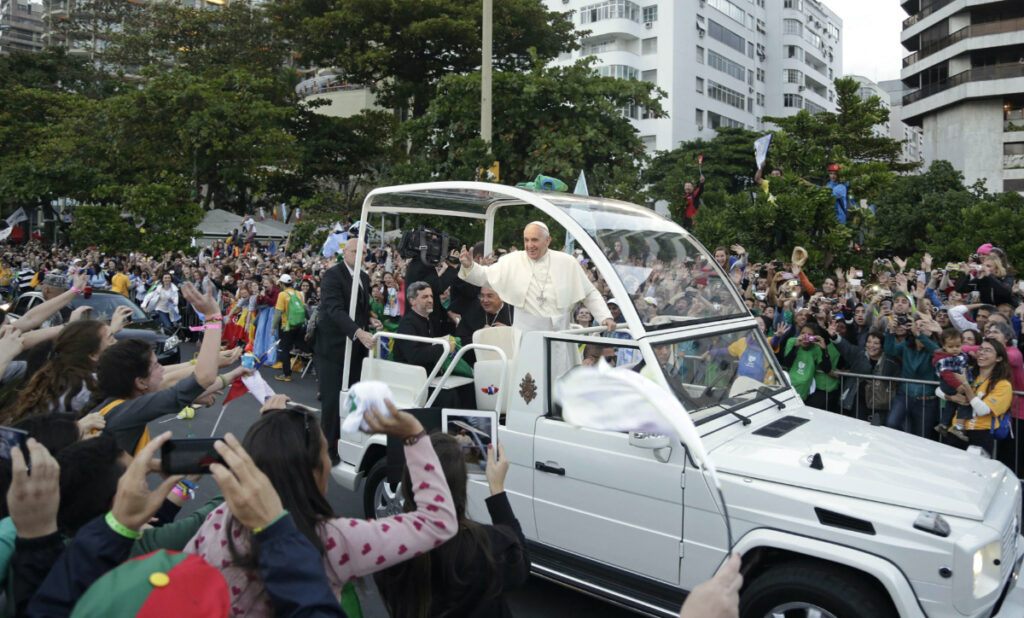 Pope Francis waves to people from his popemobile along the Copacabana beachfront as he arrives for the Stations of the Cross procession in Rio de Janeiro, Brazil, on Friday, 26th July, 2013.