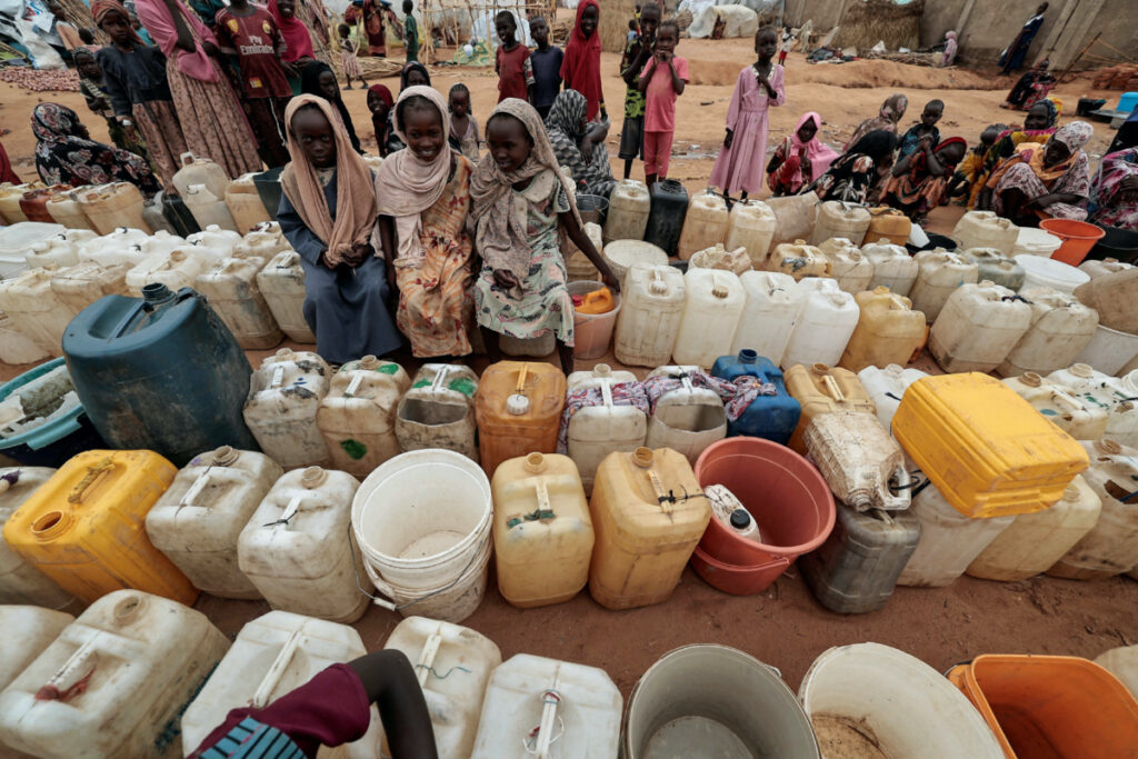 Sudanese girls who fled the conflict in Geneina, in Sudan's Darfur region, line up at the water point in Adre, Chad on 30th July, 2023.