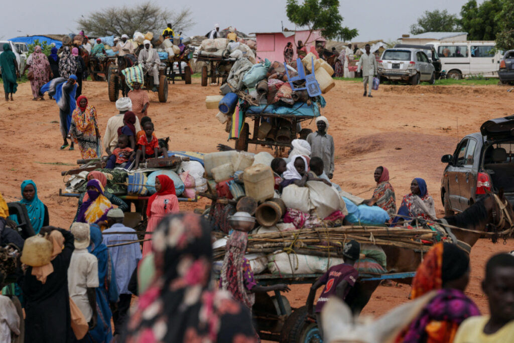 Chadian cart owners transport belongings of Sudanese people who fled the conflict in Sudan's Darfur region, while crossing the border between Sudan and Chad in Adre, Chad, on 4th August, 2023.