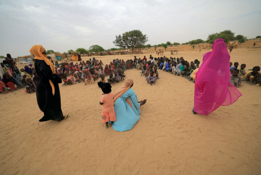 Zahra Haroun, 19, Nawal Adama, 32, Zahra Mohamed, 20, Sudanese refugee teachers who have fled the violence in Sudan's Darfur region, give their first entertainment and sport training session for refugee children at makeshift shelters near the border between Sudan and Chad in Koufroun, Chad on 11th May, 2023.