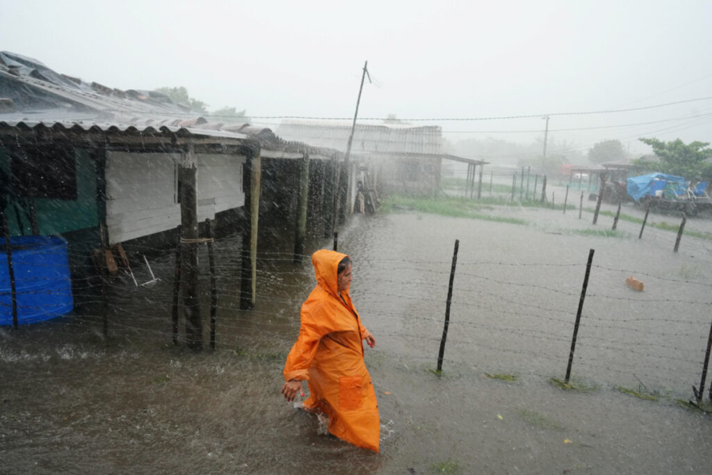 A woman walks on a flooded street as Storm Idalia makes landfall in Cuba, Guanimar, Cuba, on 28th August, 2023