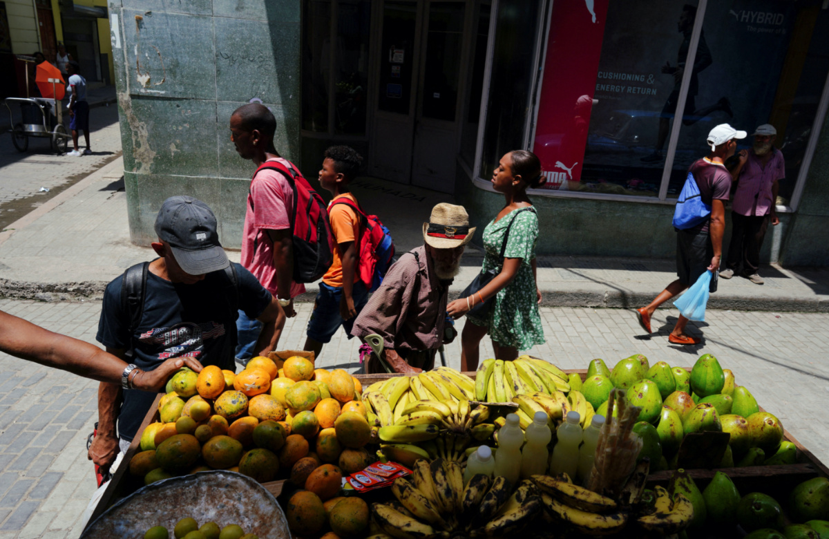 People check vegetables for sale on a cart in downtown Havana, Cuba, on 14th August, 2023