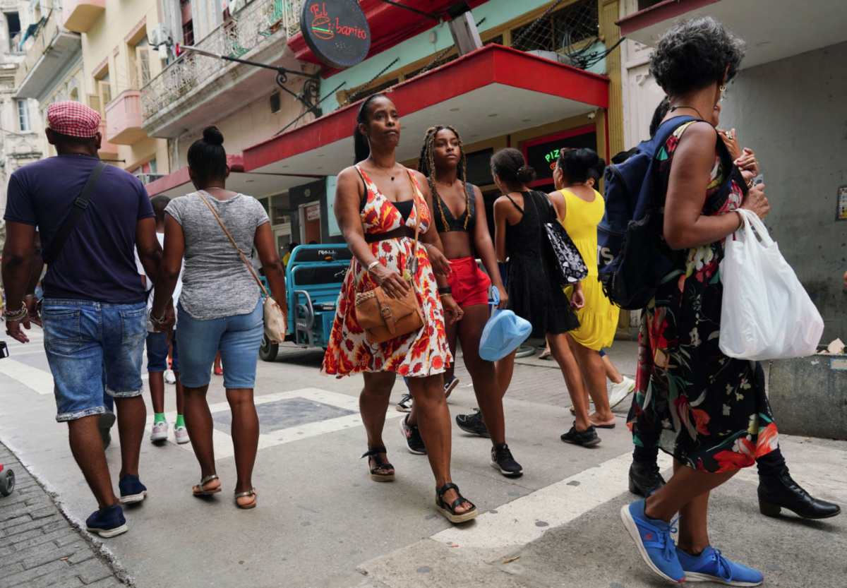People walk at a commercial street in Havana, Cuba, on 16th August, 2023.