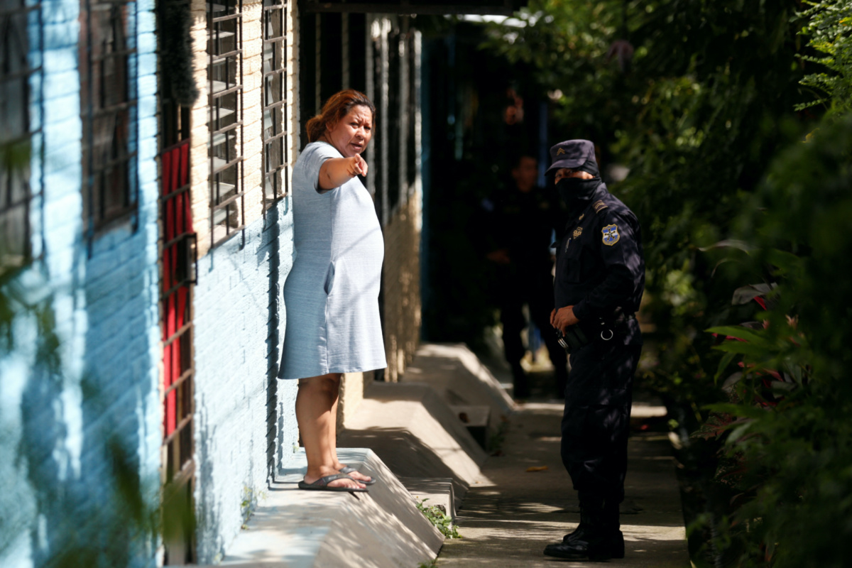 Police officer talks with a woman during a "Casa Segura" operation as part of the state of emergency to fight gangs, at the Altavista neighbourhood in Tonacatepeque, El Salvador, on 17th August, 2022